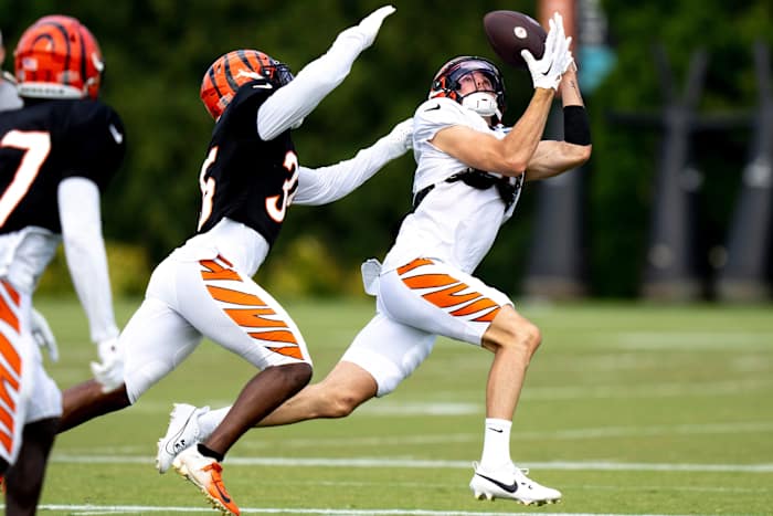 Cincinnati Bengals wide receiver Charlie Jones (15) catches a pass as Cincinnati Bengals cornerback Jalen Davis (35) guards him at the Cincinnati Bengals NFL training camp practice in Cincinnati on Thursday, Aug. 3, 2023.